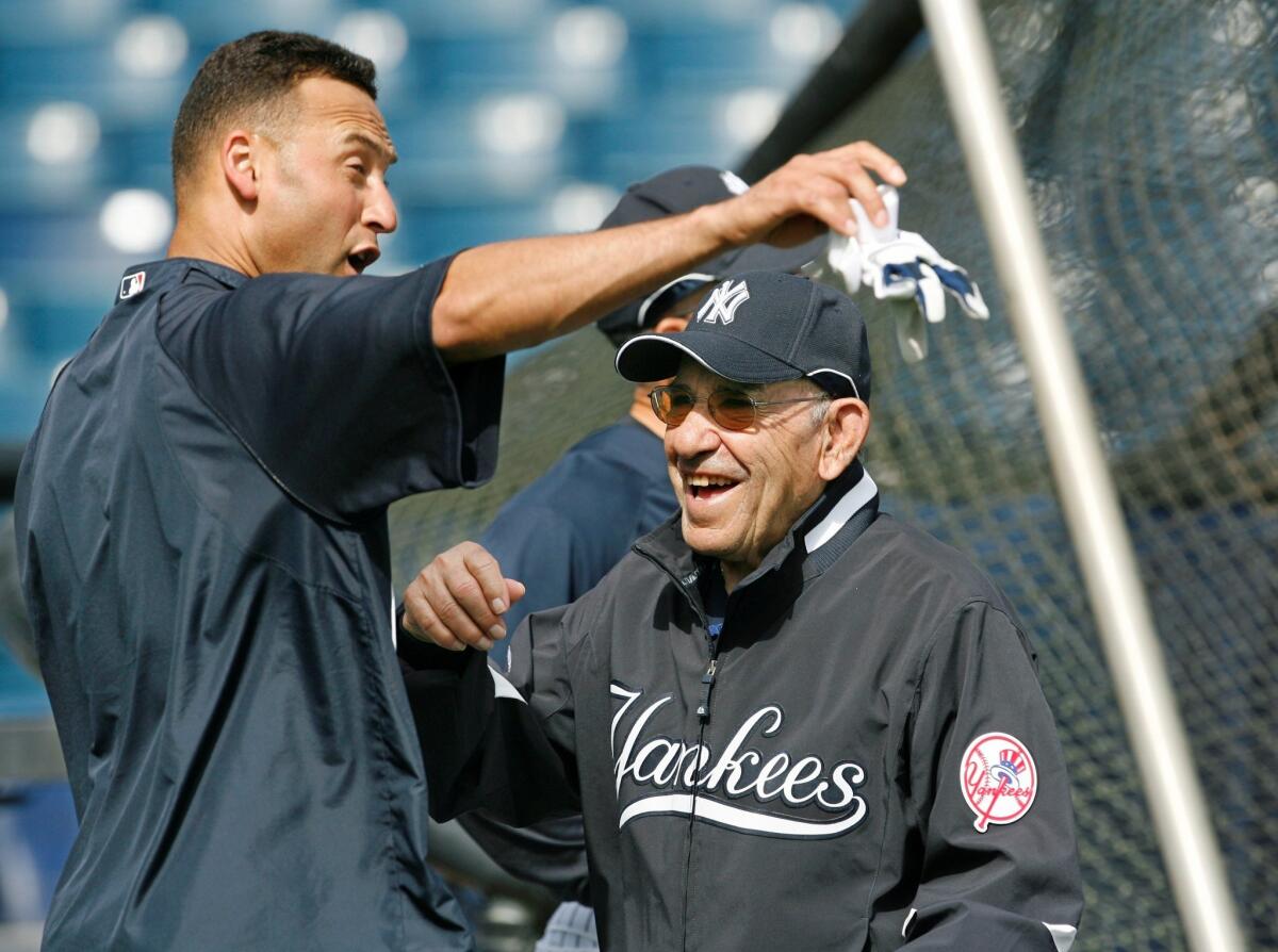 New York Yankees legends Yogi Berra, right, and Derek Jeter have some during spring training in 2008.