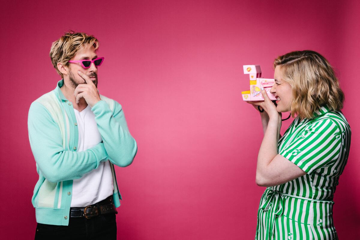 Greta Gerwig takes a Polaroid of Ryan Gosling wearing hot-pink sunglasses