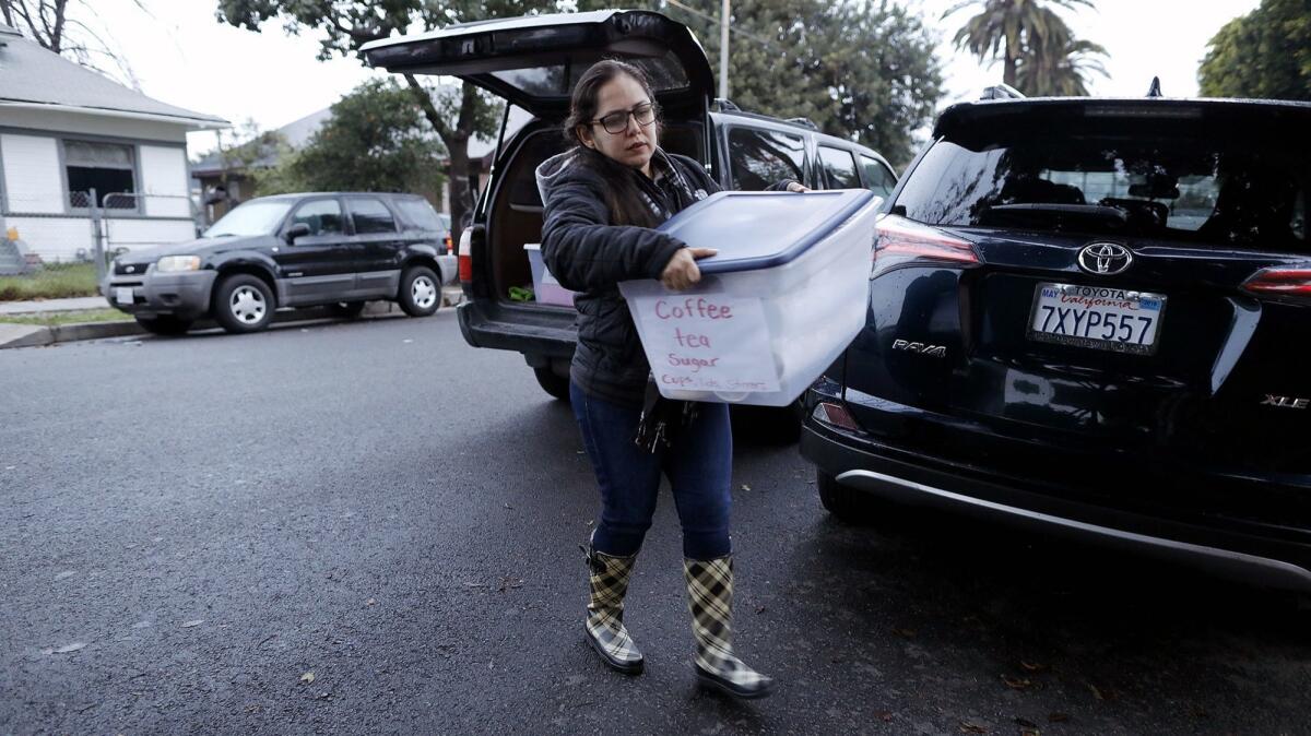 Alejandra Delgadillo, who lives across from Trinity Elementary, unloads supplies for striking LAUSD teachers.