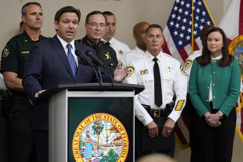 Florida Gov. Ron DeSantis, surrounded by members of law enforcement
