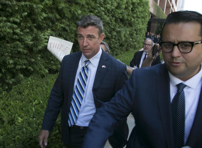 Duncan D. Hunter, left, departs the Federal courthouse in San Diego after he pleaded not guilty to charges that he and his wife Margaret Hunter misused $250,000 in campaign contributions.