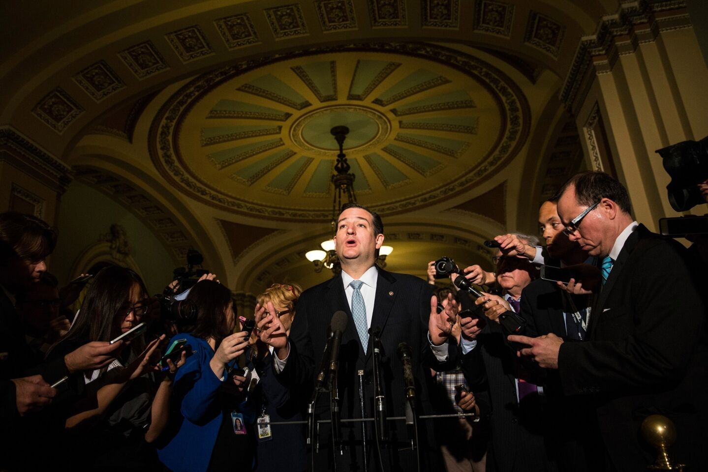 Sen. Ted Cruz (R-Texas), who railed against any government funding for federal healthcare, answers questions from members of the media after meeting with Republican senators.