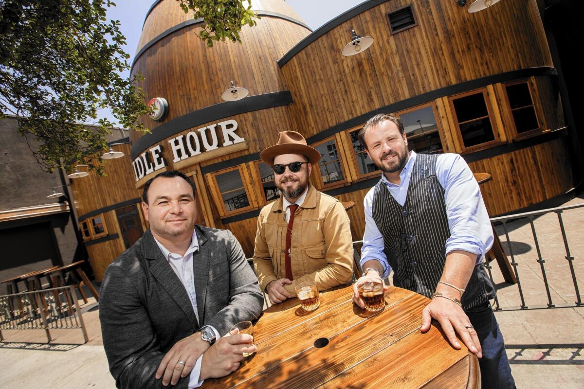 1933 Group owners Dmitry Liberman, left, Bobby Green and Dimitri Komarov in front of their latest restaurant and bar, Idle Hour, in North Hollywood.