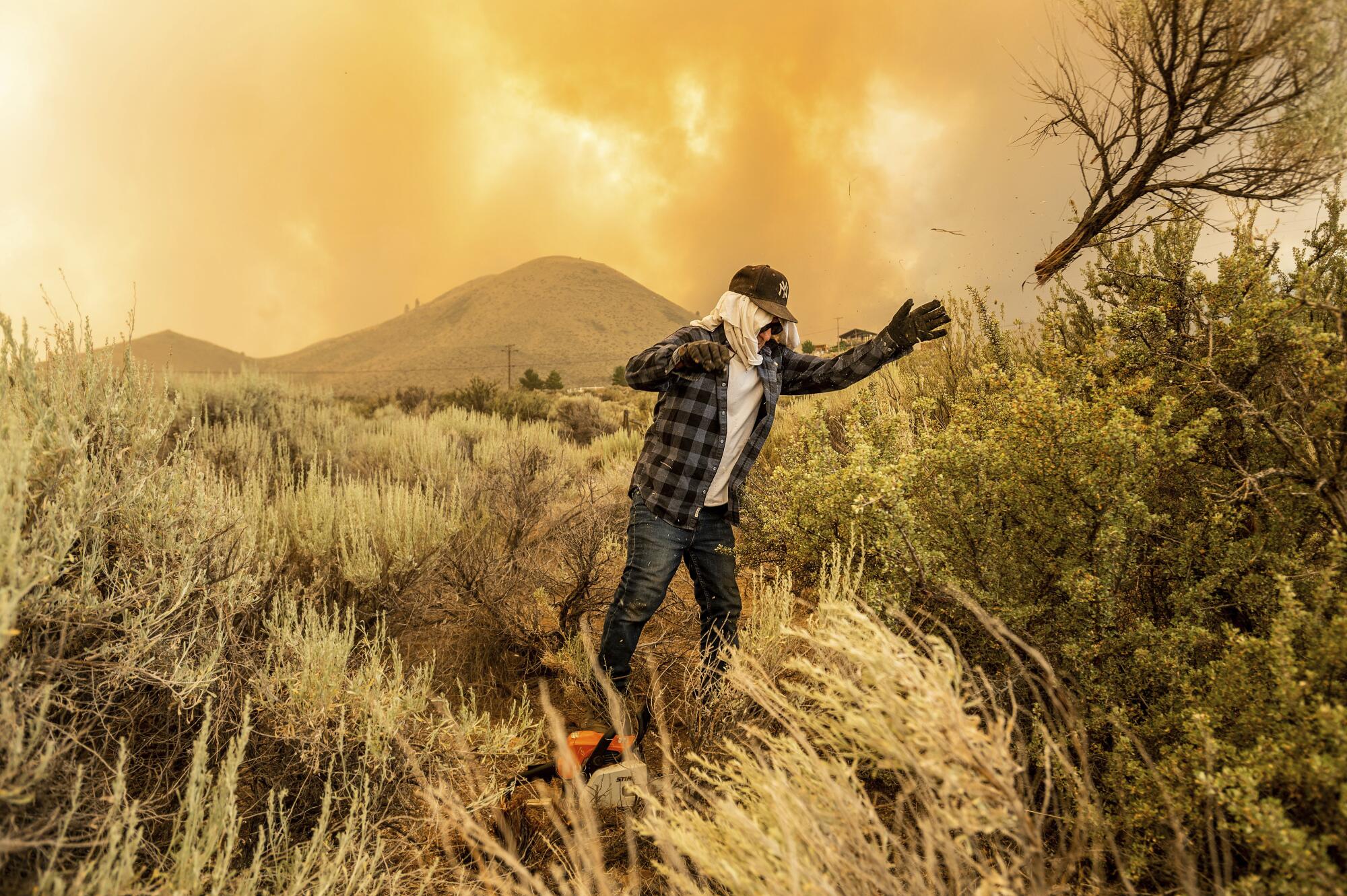 A man in a field with flames in the background