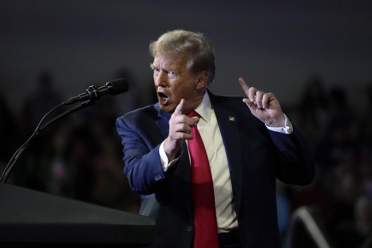 Trump gestures while speaking at a rally