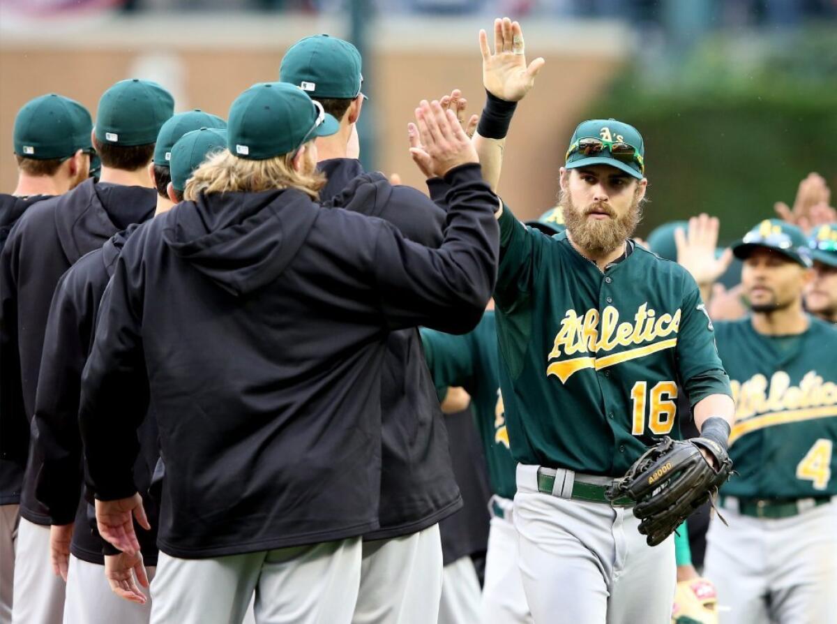 The A's celebrate their Game 3 win over the Tigers.