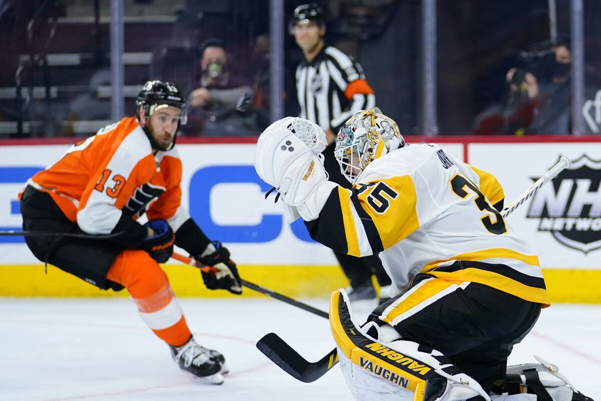 Pittsburgh Penguins' Tristan Jarry, right, blocks a shot as Philadelphia Flyers' Kevin Hayes looks on during the third period of an NHL hockey game, Tuesday, May 4, 2021, in Philadelphia. (AP Photo/Matt Slocum)
