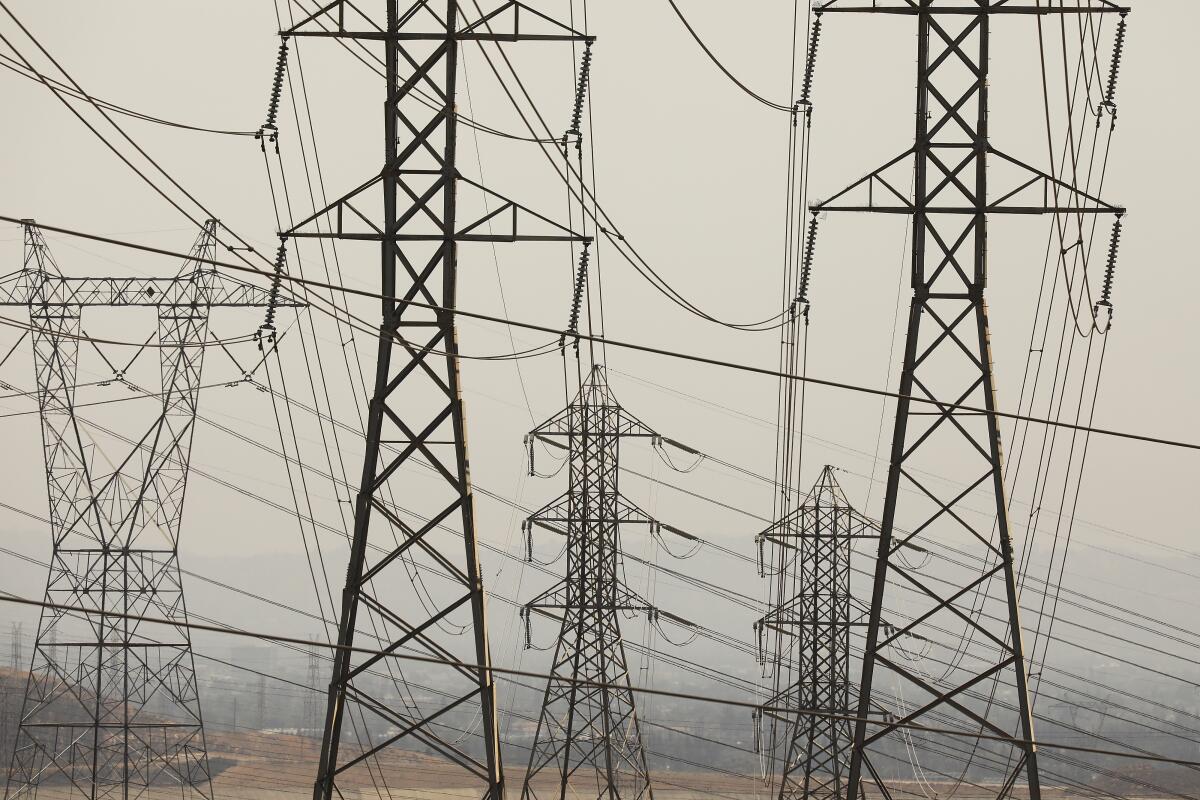 Transmission towers crisscrossed by wires.