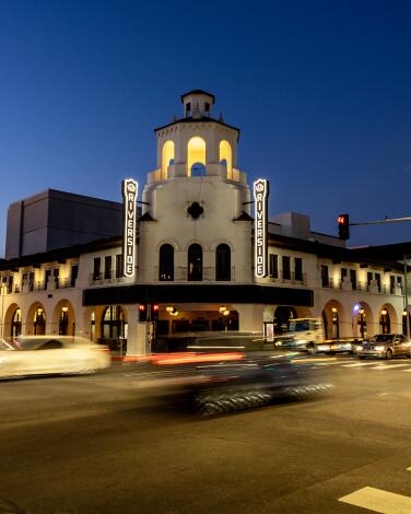 The Fox Theater, a Spanish Colonial Revival style building in the heart of downtown Riverside, at dusk.