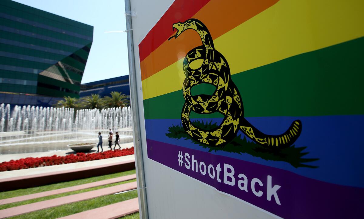 A poster featuring a rainbow-colored version of the Gadsden flag and the hashtag #ShootBack in front of the Pacific Design Center in West Hollywood.