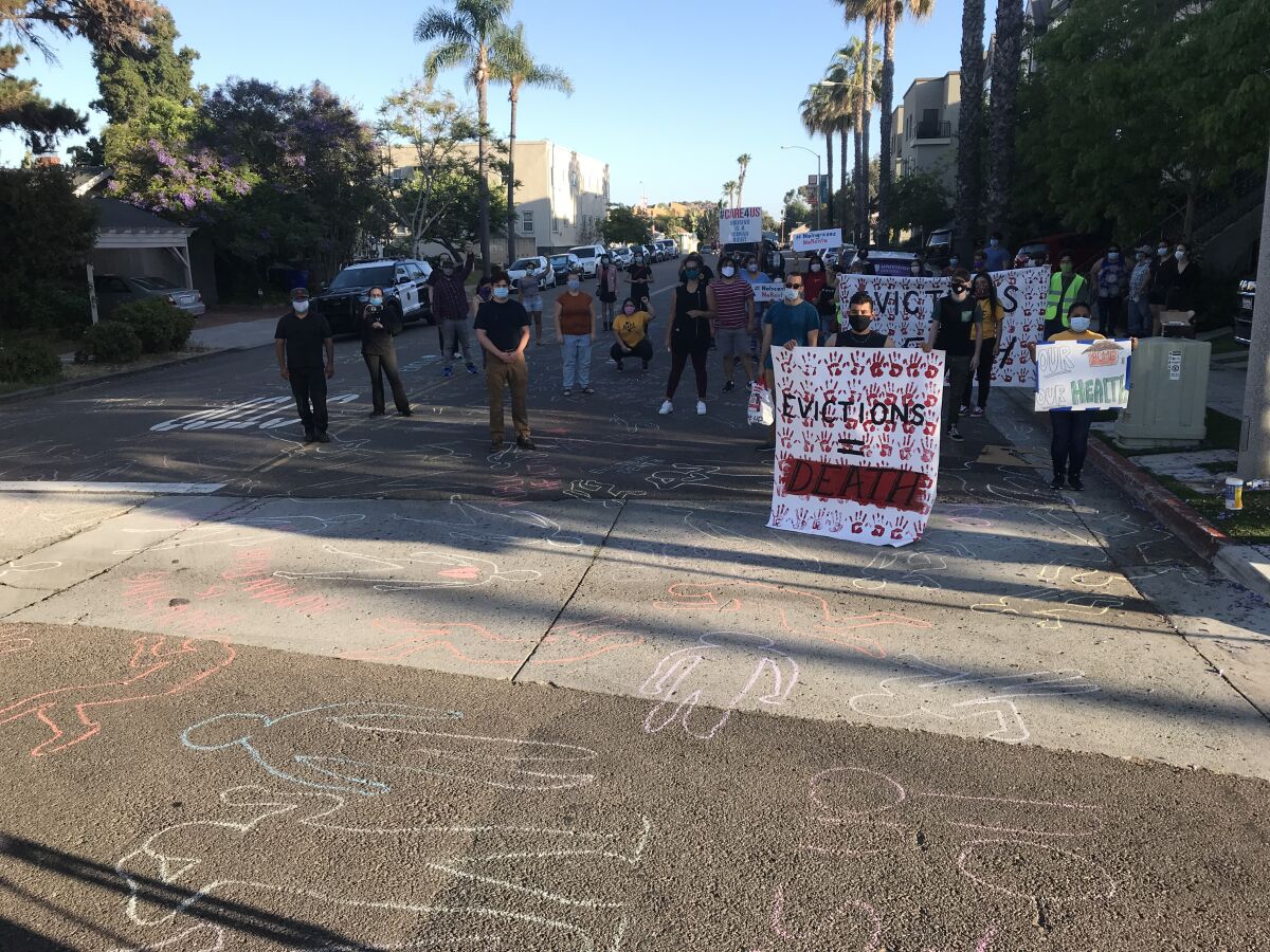 Anti-eviction protesters drew chalk outlines of bodies on a road near San Diego County Sheriff Bill Gore's home in Mission Hills on Tuesday.