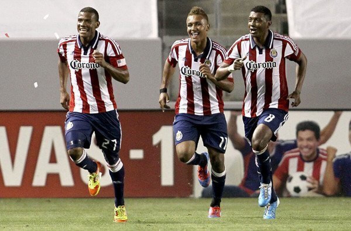 Chivas USA players Jose Erick Correa, left, Juan Agudelo and Oswaldo Minda celebrate after Correa converted a penalty kick against the Galaxy during an MLS game at Home Depot Center last season.