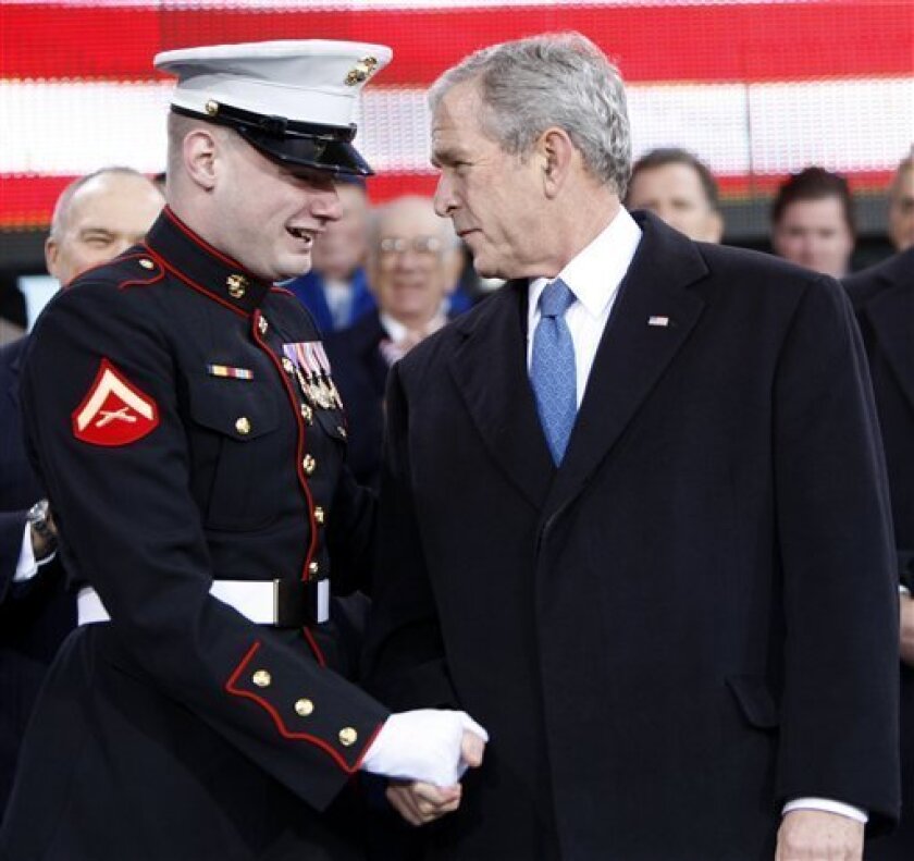 President Bush talks with wounded Marine Lance Corp. Matt Bradford during the rededication ceremony of the Intrepid Sea, Air and Space Museum in New York, Tuesday, Nov. 11, 2008. In January of 2007, Bush watched the multiple amputee Marine climb a rock wall and plant the Marine Corp flag at the top during a visit to the Center for the Intrepid in San Antonio. (AP Photo/Gerald Herbert)