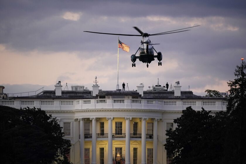 President Donald Trump arrives back at the White House aboard Marine One, Monday evening, Oct. 5, 2020 in Washington, after being treated for COVID-19 at Walter Reed National Military Medical Center. The president's personal physician, Dr. Sean Conley, told reporters on Monday afternoon that Trump is not out of the woods yet, but that there is no care at the hospital that the president cannot get at the White House. (AP Photo/J. Scott Applewhite)