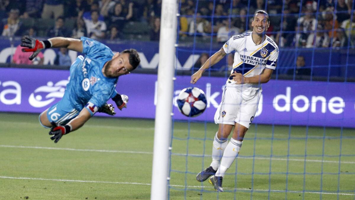 Galaxy forward Zlatan Ibrahimovic, right, scores past Toronto FC goalkeeper Quentin Westberg during the second half of a 2-0 victory Thursday.