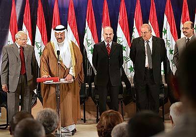Members of the new Iraqi government are sworn into office today, including President Ghazi Al-Yawer, Vice President Ibrahim Al-Jaafari, Prime Minister Iyad Allawi, and Deputy Prime Minister Barham Salih. They are sworn in by Chief Justice Midhat al-Mahmoudi, far left, at the Headquartes of the Governing Council.