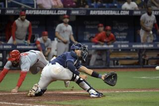 Los Angeles Angels' Anthony Rendon, left, beats the throw to Tampa Bay Rays catcher Rene Pinto to score the go-ahead run during the ninth inning of a baseball game Wednesday, April 17, 2024, in St. Petersburg, Fla. (AP Photo/Steve Nesius)