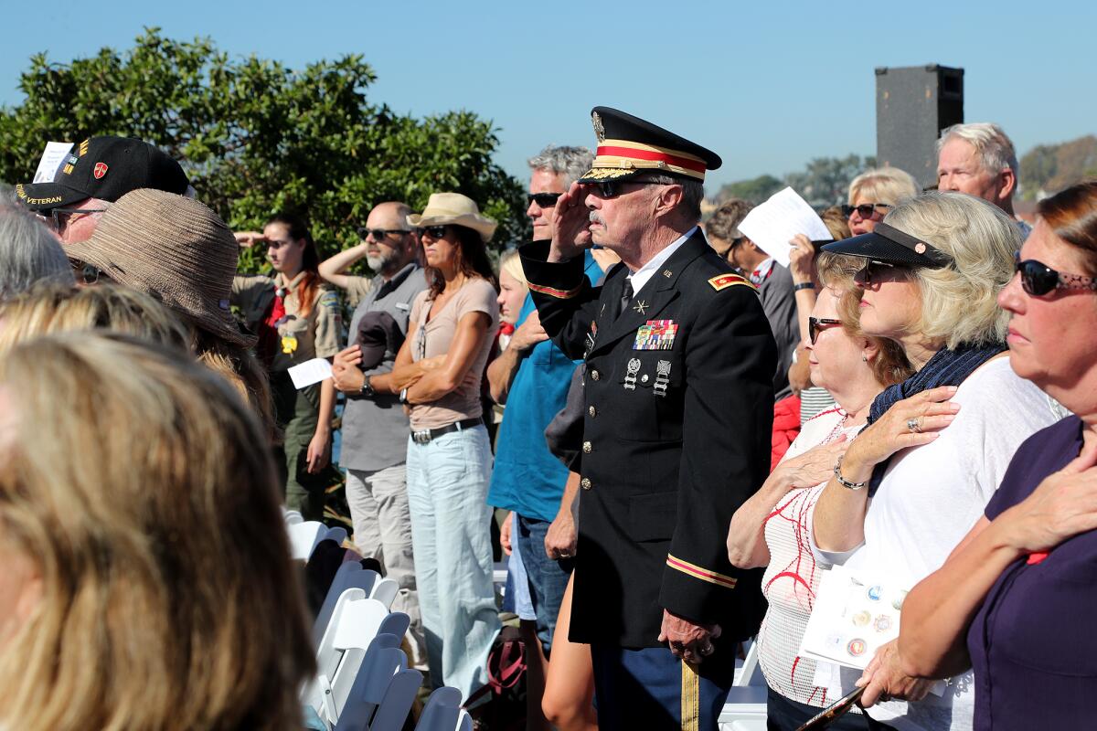 Vietnam veteran Al Harvard, U.S. Army major retired, salutes the flag as the pledge of allegiance is recited.