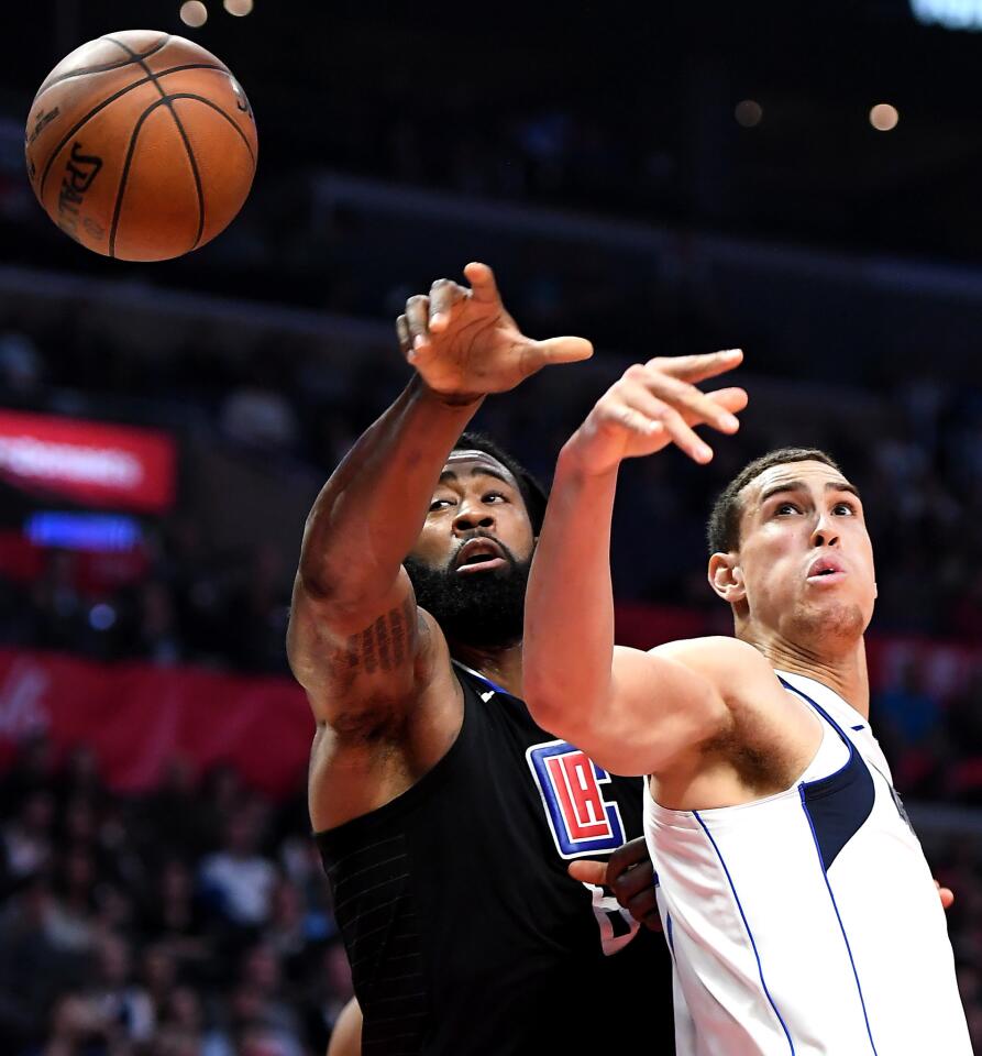 Clippers DeAndre Jordan and Mavericks Salah Mejri battle for a rebound.