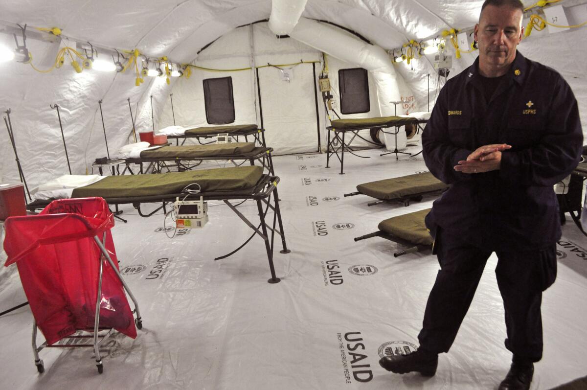 A health worker stands inside a medical tent that forms part of a new Ebola treatment unit built by the U.S. on the outskirts of the Liberian capital, Monrovia.