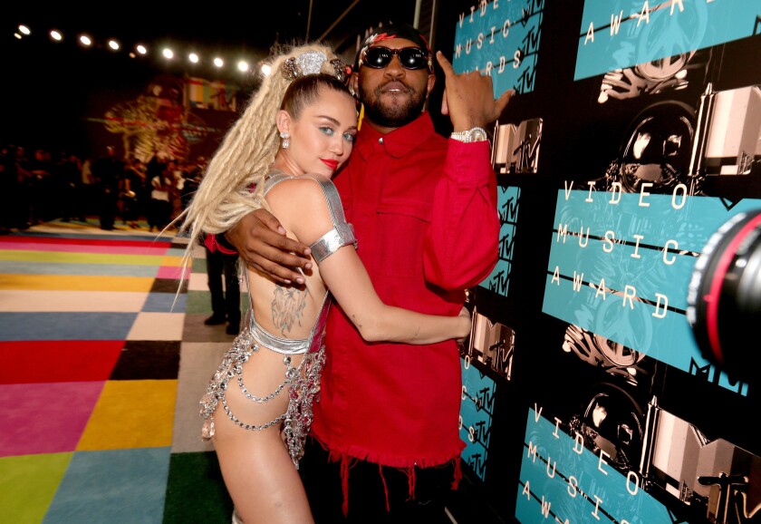 Show host Miley Cyrus and music producer Michael Len Williams II pose outside the 2015 MTV Video Music Awards, held at the Microsoft Theater in downtown L.A. on Aug. 30.