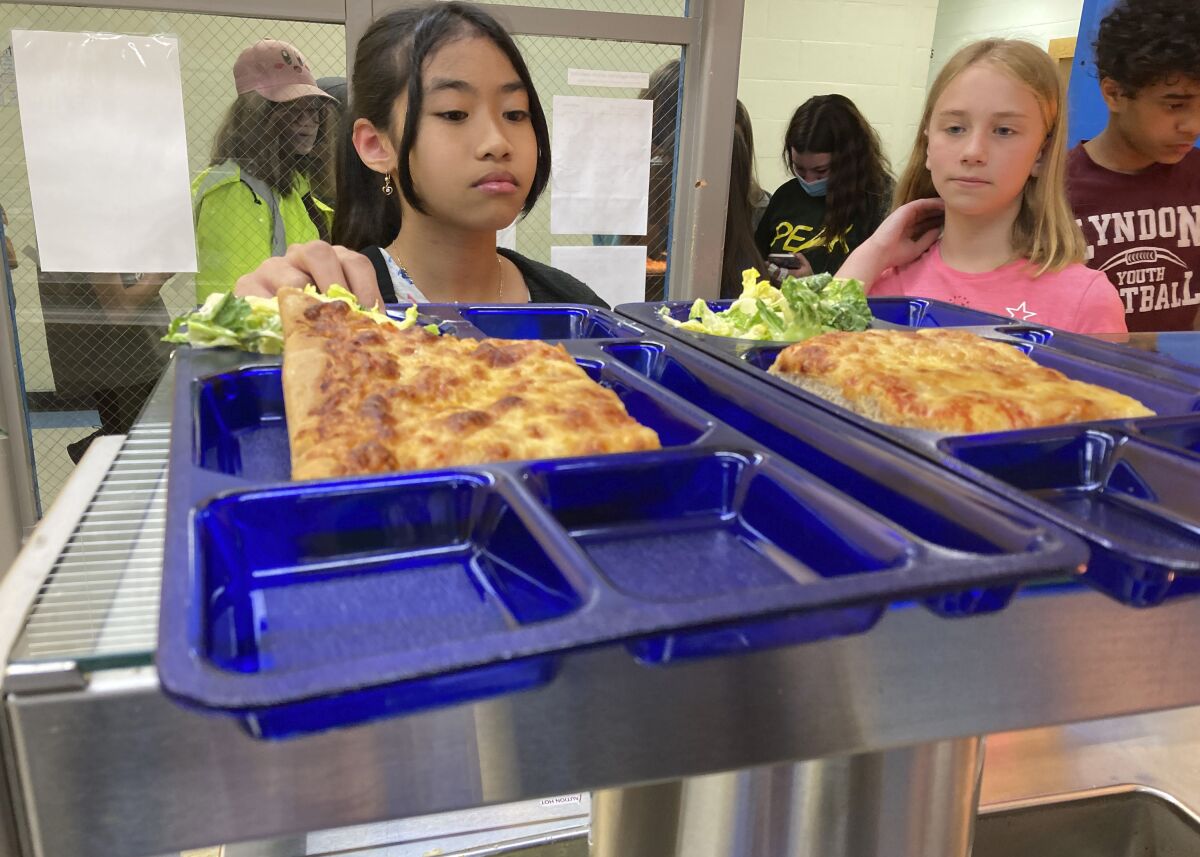 Students get lunch of homemade pizza and caesar salad.