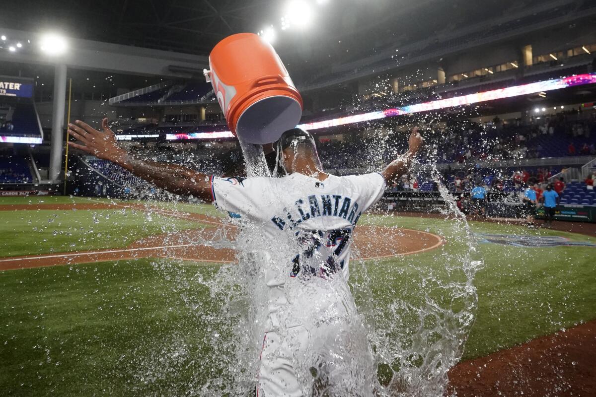 Miami Marlins starting pitcher Sandy Alcantara is doused by Pablo Lopez after the Marlins beat the Cincinnati Reds 3-0 in a baseball game, Wednesday, Aug. 3, 2022, in Miami. (AP Photo/Wilfredo Lee)