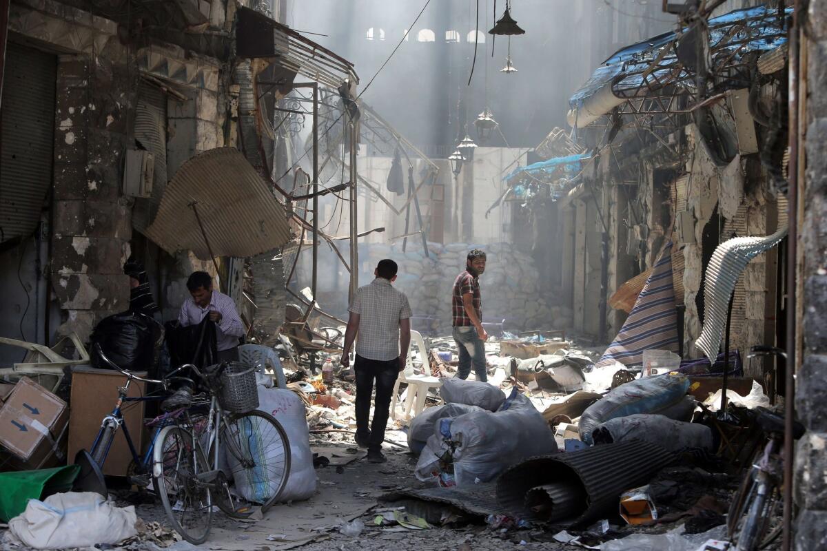 Residents of the Old City of Homs inspect their destroyed neighborhood.