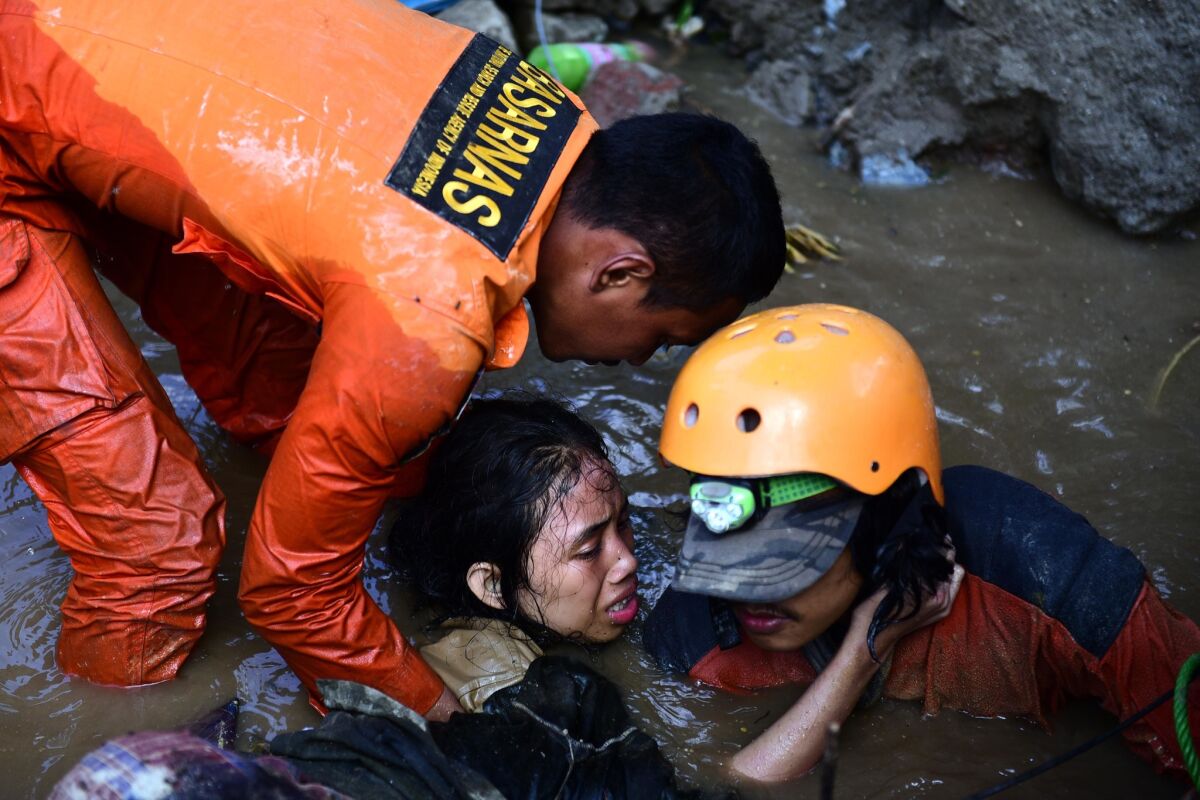 Rescuers try to free 15-year-old earthquake survivor Nurul Istikhomah from the flooded ruins of a collapsed house in Palu, Indonesia.