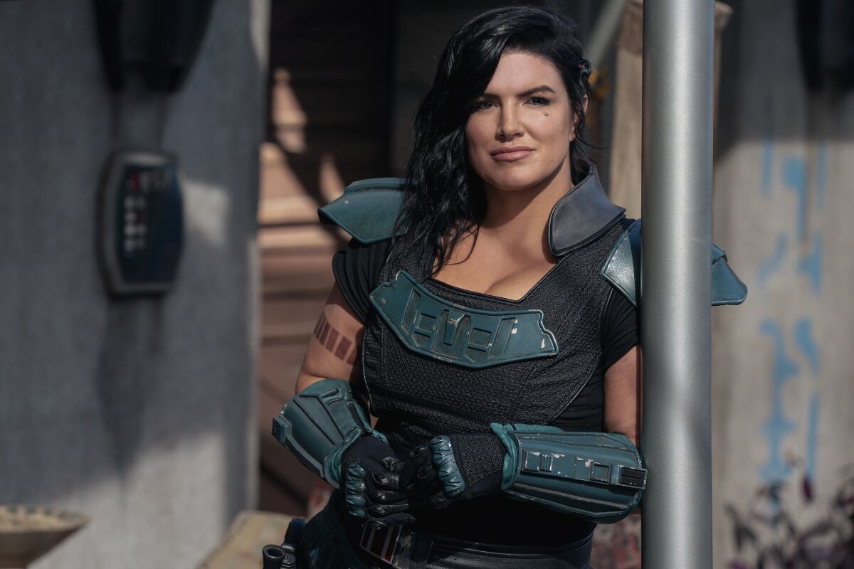 Gina Carano leans against a pole in character as Cara Dune in 'The Mandalorian'