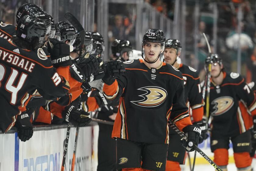 Anaheim Ducks center Troy Terry (19) celebrates with his team after scoring during the first period of an NHL hockey game against the Carolina Hurricanes in Anaheim, Calif., Thursday, Nov. 18, 2021. (AP Photo/Ashley Landis)