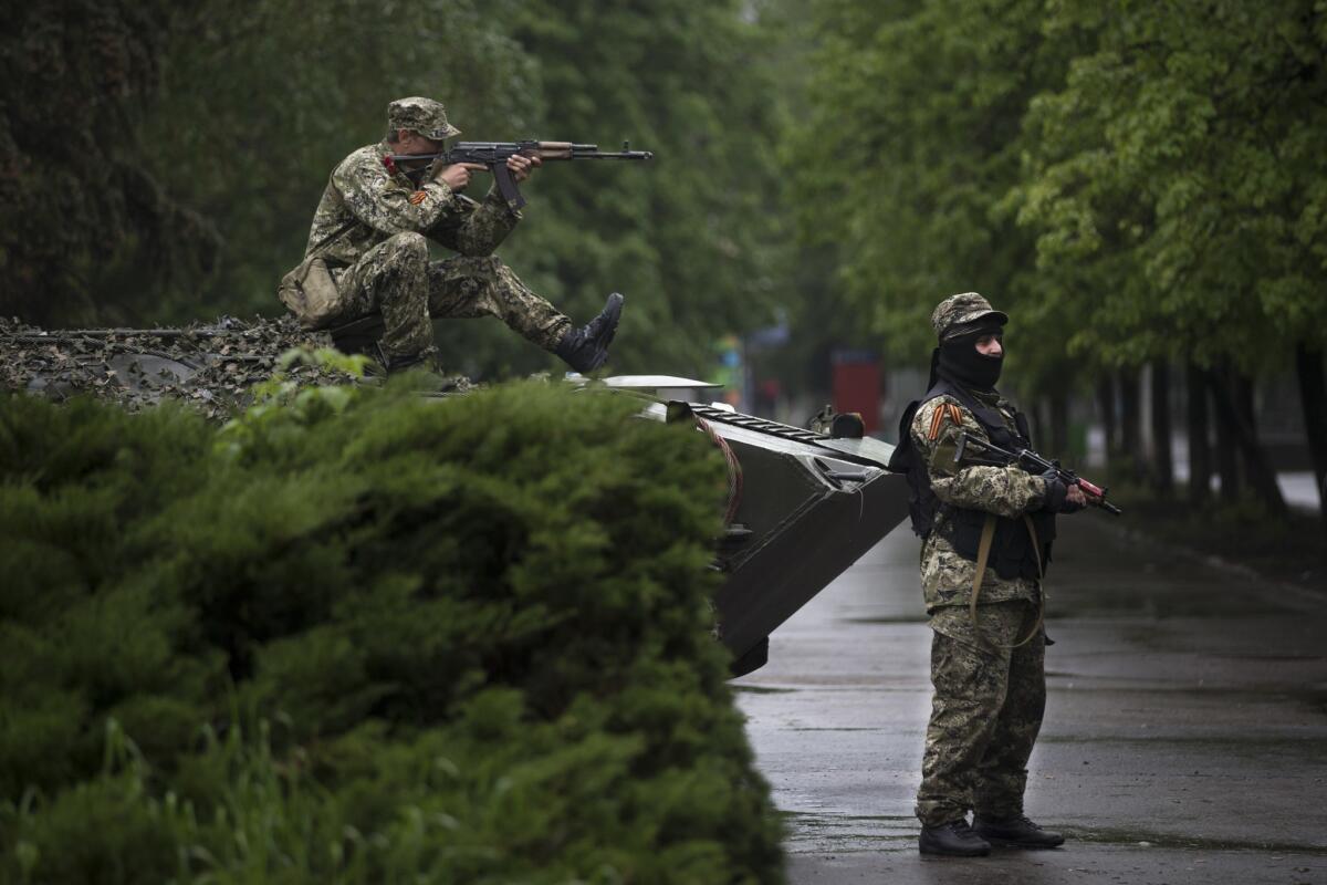 Pro-Russia separatists guard the central square of Slovyansk in eastern Ukraine on Friday. The town has been the scene of numerous detentions and beatings of journalists and others seeking to monitor the escalating violence in the region.