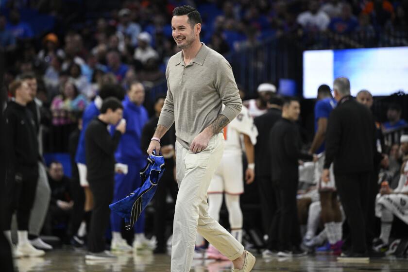 FILE - Former Orlando Magic guard JJ Redick, center, leaves the court after being honored by the team during the first half of an NBA basketball game against the New York Knicks, Wednesday, Feb. 14, 2024, in Orlando, Fla. The Los Angeles Lakers’ reported plan to offer a massive contract to UConn coach Dan Hurley is the latest twist in the monthlong race to replace Darvin Ham. According to a person with knowledge of the lengthy search, the Lakers have strongly considered J.J. Redick, the former player and current ESPN analyst. (AP Photo/Phelan M. Ebenhack, File)
