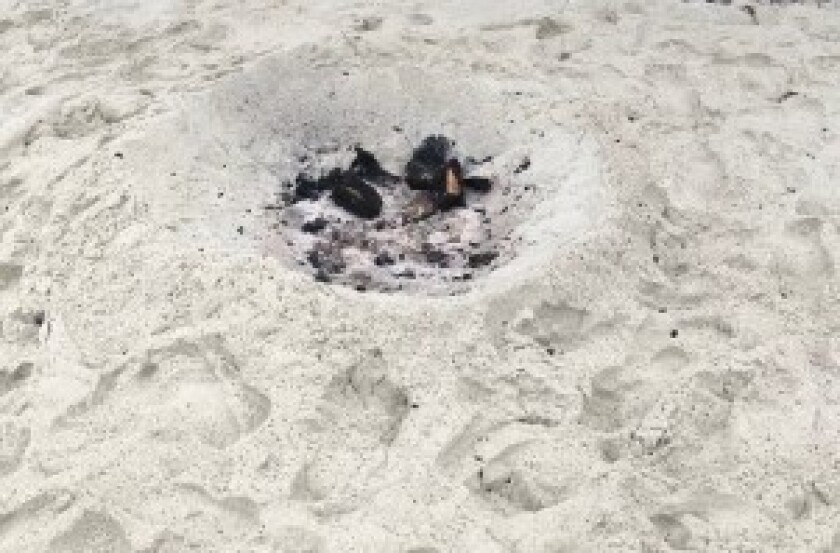 Illegal beach fires that leave burnt remnants in the sand have been a concern at San Diego beaches, including in La Jolla.