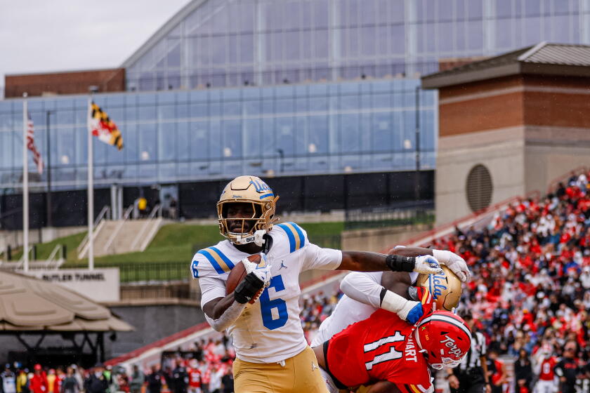 UCLA running back Anthony Woods runs for a touchdown against Maryland on Saturday.