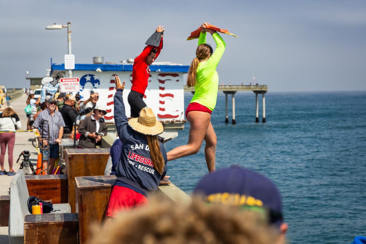 A Junior Lifeguard jumps off the Ocean Beach Pier during a fundraiser for the Prevent Drowning Foundation of San Diego.
