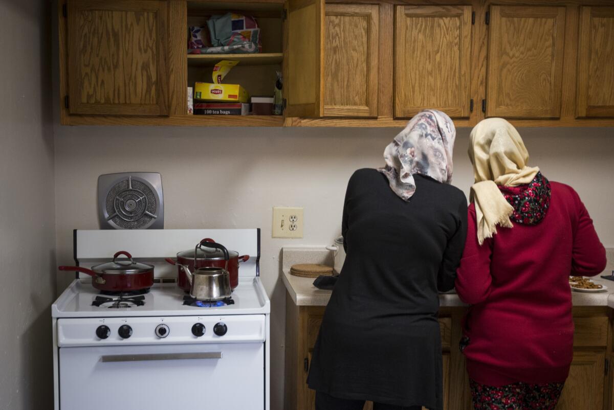 Two Syrian women who arrived in the U.S. on Feb. 7 settle into their apartment in Landover, Md.