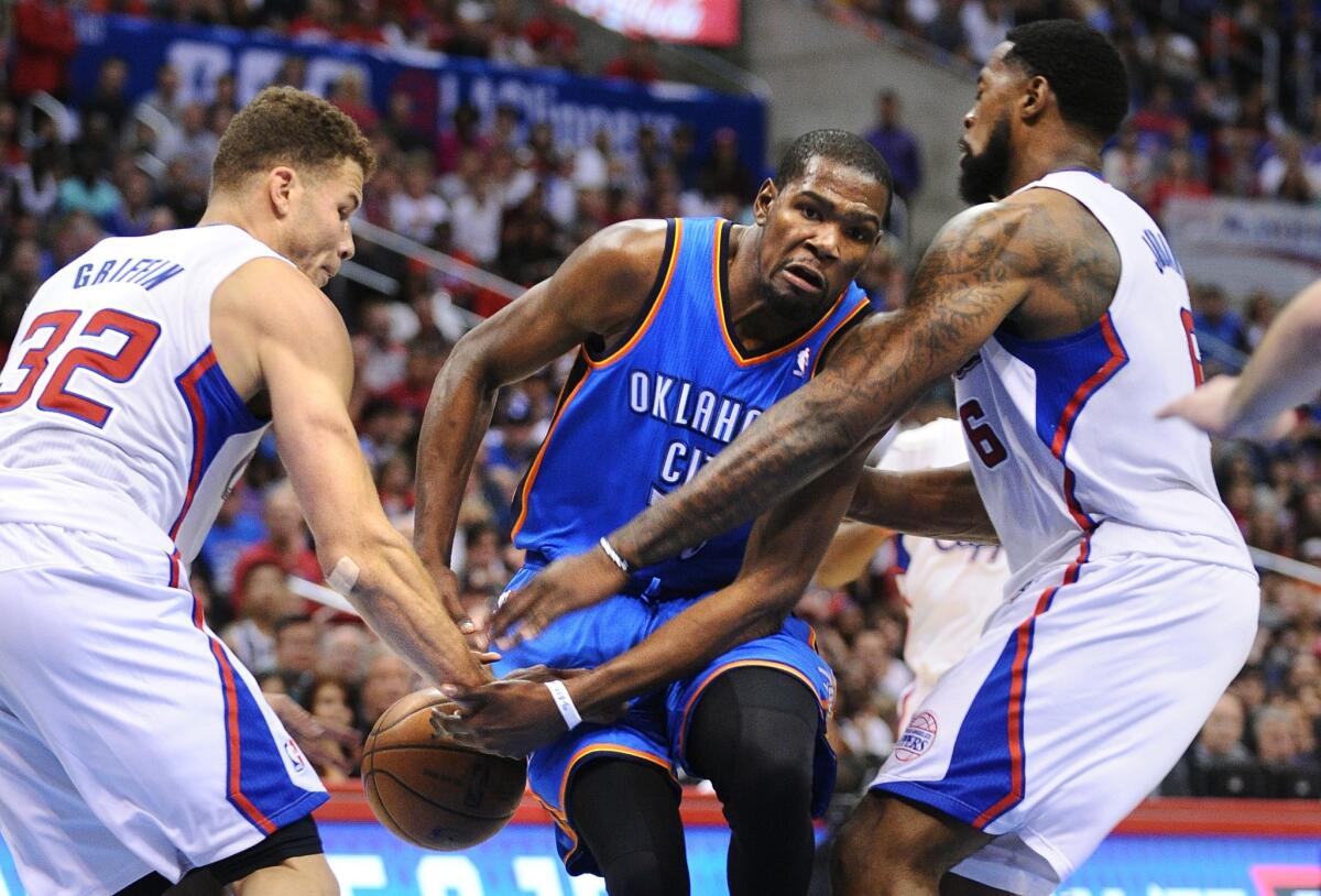 Clippers power forward Blake Griffin strips the ball from Thunder forward Kevin Durant as he tries to drive to the basket against Griffin and center DeAndre Jordan.