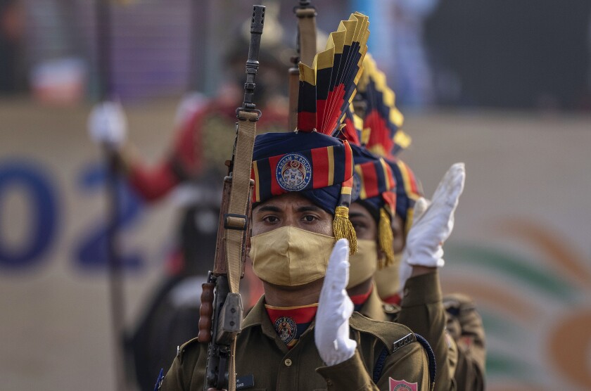 Members of Assam Police battalion wearing masks as a precaution against coronavirus take part in the Republic Day parade in Gauhati, India, Wednesday, Jan. 26, 2022. The day marks the anniversary of the adoption of the country’s constitution in 1950. (AP Photo/Anupam Nath)