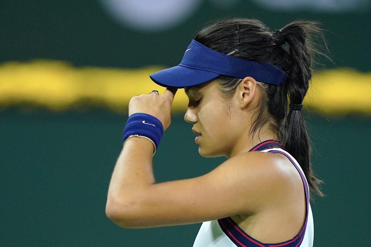 Emma Raducanu wipes her head after losing a point to Aliaksandra Sasnovich at the BNP Paribas Open in Indian Wells.