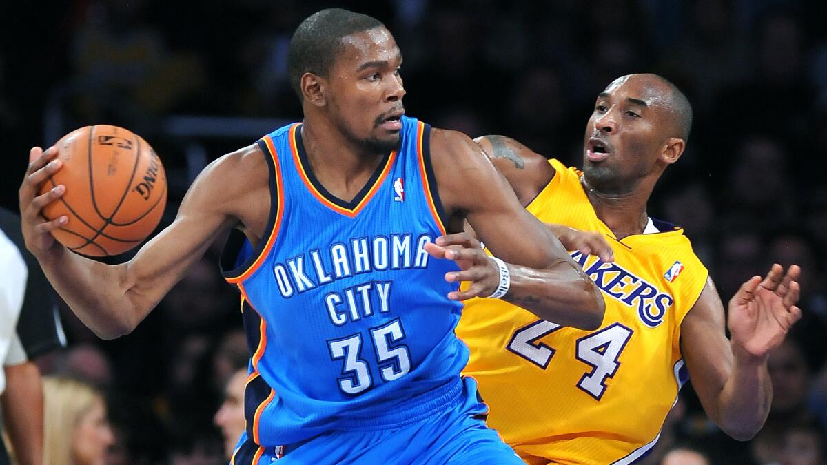 Oklahoma City's Kevin Durant operates against the Lakers' Kobe Bryant during a game at Staples Center on Jan. 11, 2013.