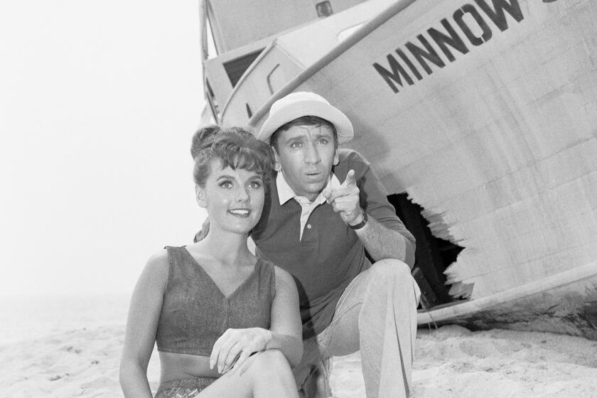 Gilligan's Island cast members, from left, Dawn Wells and Bob Denver appearing in the pilot episode.