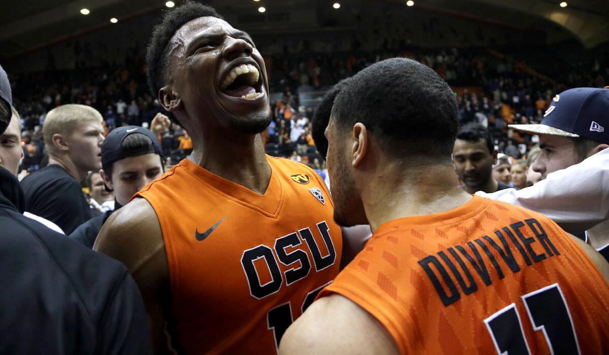 Oregon State guard Langston Morris-Walker celebrates with teammate Malcolm Duvivier after defeating No. 7-ranked Arizona, 58-56, on Sunday night in Corvallis, Ore.