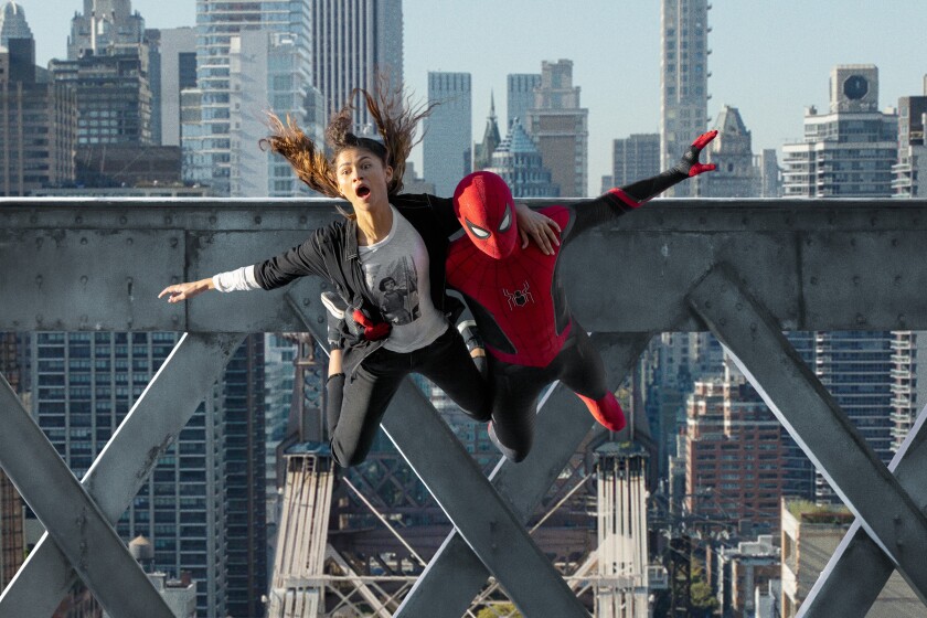 Spider-Man holds a woman as they jump off a bridge with New York City behind them.