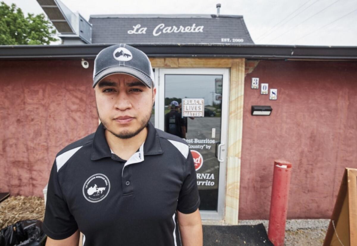 Alfonso Medina of La Carreta Mexican Grill in Marshalltown, Iowa, stands in front of his restaurant.