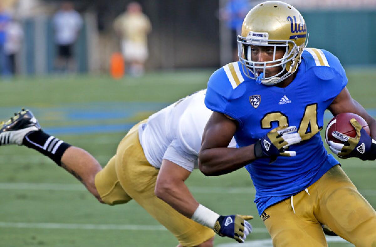 Bruins running back Paul Perkins turns the corner on a run during the spring game Saturday at the Rose Bowl.