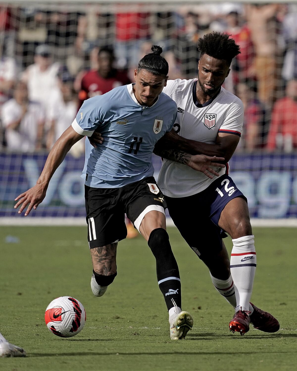 Uruguay forward Darwin Nunez (11) and USA defender Erik Palmer-Brown (12) chase the ball during the second half of an international friendly soccer match Sunday, June 5, 2022, in Kansas City, Kan. The match ended in a 0-0 tie. (AP Photo/Charlie Riedel)