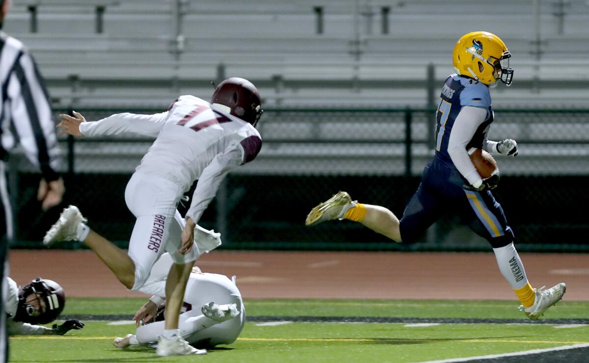 Marina's Gavin Dykema scores a touchdown in a home game vs. Laguna Beach at Boswell Field in Westminster on Thursday.