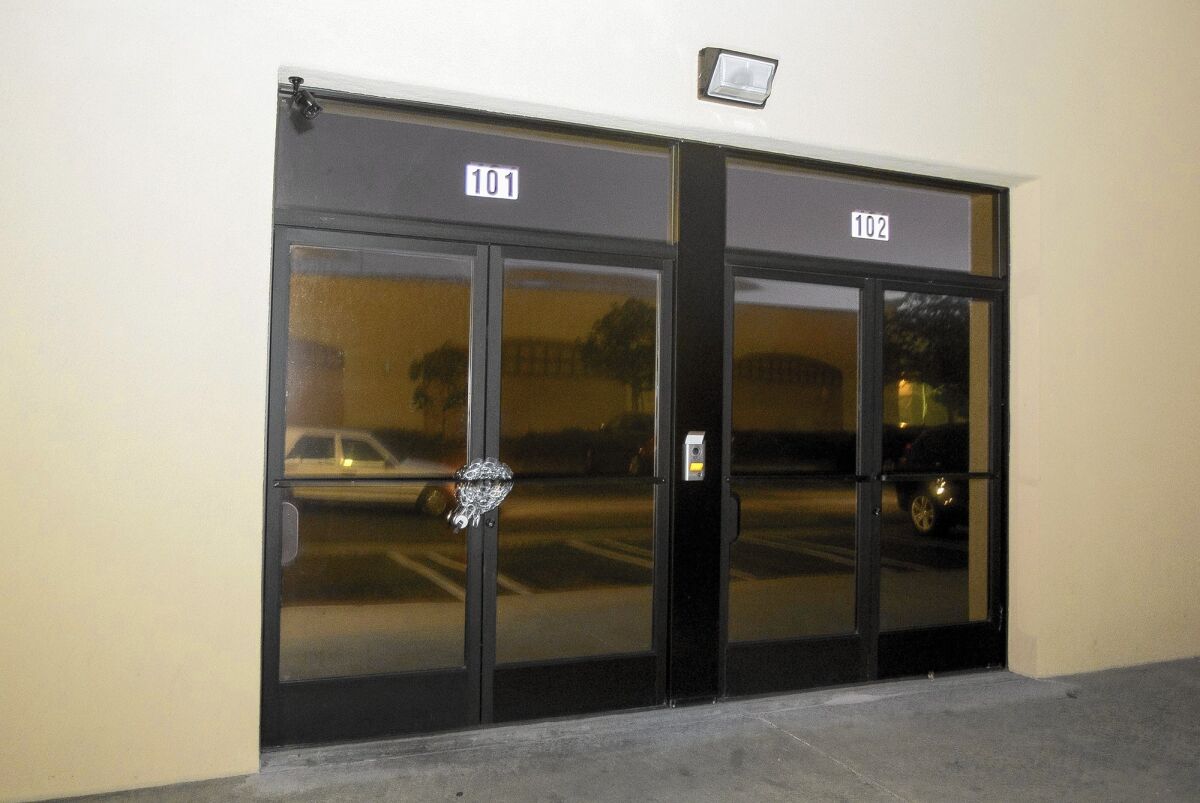 The door is chained after Costa Mesa police raided a Harbor Boulevard storefront that they believed was a marijuana dispensary but a lawyer says is a new location of Oklevueha Native American Church.
