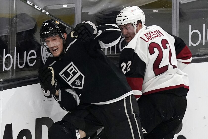 Los Angeles Kings defenseman Austin Strand, left, collides with Arizona Coyotes left wing Johan Larsson during the second period of an NHL hockey game Wednesday, April 7, 2021, in Los Angeles. (AP Photo/Marcio Jose Sanchez)